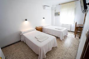Postel nebo postele na pokoji v ubytování Hostal Residencia Pasaje