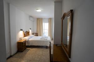 Postel nebo postele na pokoji v ubytování Hostal Residencia Pasaje