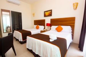 Postel nebo postele na pokoji v ubytování Playa Caracol Hotel & Spa