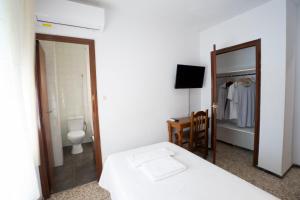 Postel nebo postele na pokoji v ubytování Hostal Residencia Pasaje