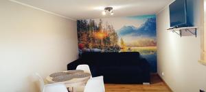 a living room with a painting on the wall at Apartament Olczański Chëcz in Zakopane