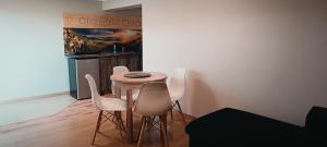 a kitchen with a table and chairs in a room at Apartament Olczański Chëcz in Zakopane