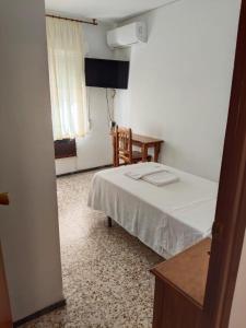 Postel nebo postele na pokoji v ubytování Hostal Residencia Pasaje