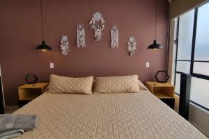 a bedroom with a large bed and some decorations on the wall at Viñedito del coyote, Coyoacán in Mexico City