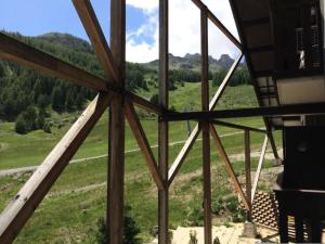 a view from the inside of a building with a glass window at Résidence Aurans - Joli deux pièces au cœur de la station de Réallon 223A MAE-8391 in Réallon