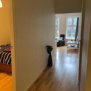 a living room with a vase on the floor at Engen 6 in Bergen +6 photos