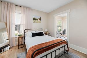 a bedroom with a bed and two windows at Beautiful 2 Bed 1 Bath home near College Hill in Wichita