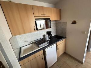 eine kleine Küche mit Spüle und Mikrowelle in der Unterkunft Résidence Gardette - Superbe vue sur les montagnes de ce T2 à Réallon A13 MAE-9051 in Réallon + 2 Fotos