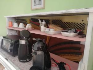 a kitchen shelf with dishes and utensils on it at Agriturismo A Cà Vegia in Calice Ligure