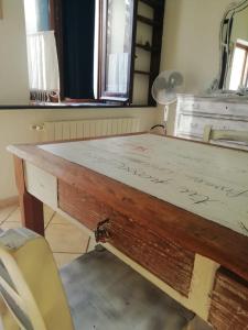 a wooden table in a room with a desk at Agriturismo A Cà Vegia in Calice Ligure