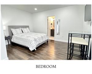 鲁兹Getaway Private Suite A的一间卧室，里面有一张床、一张桌子和一把椅子