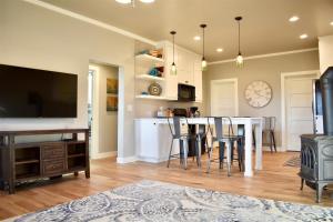 a kitchen and living room with a table and a stove at Bluebird Day - Fuller Cottage in Bend