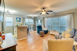 a kitchen and living room with a ceiling fan at 1 Mi to Boardwalk and Dtwn Myrtle Beach Condo in Myrtle Beach