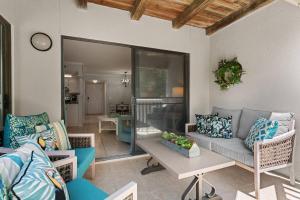 a living room with a couch and chairs at Shipwatch #114 in East End