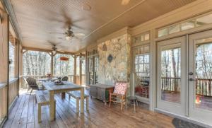 a dining room with a table and chairs on a wooden floor at Mountain Acres Retreat - Relax by the wood fireplace and more in Jasper