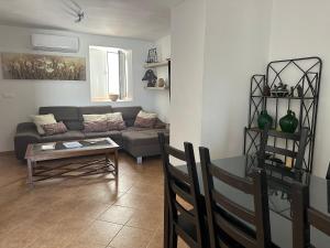 a living room with a couch and a table at Casa Cerro Luna in Constantina