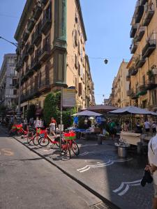 a group of red bikes parked on a city street at Ventre luxury rooms in Naples