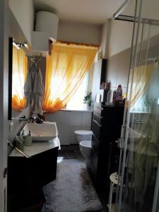 a bathroom with a sink and a toilet and a window at Focolare domestico in Milan