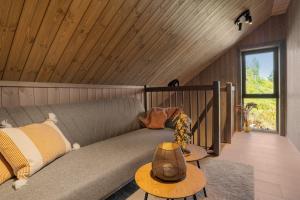 a couch in a room with a wooden ceiling at Stryn Wiew Logde Tverrfjellet in Stryn