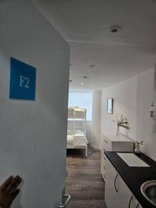 a bathroom with a sink and a bed in a room at Tavellers Room in Delta DPF2 in Croydon