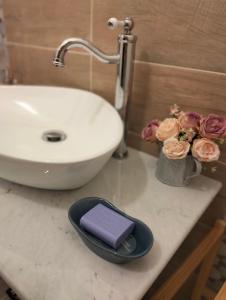 a bathroom counter with a sink and a purple wallet at Casa Crognale in Lanciano +7 photos