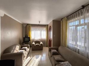 a living room with two couches and a tv at Casa Waraq in Huaraz