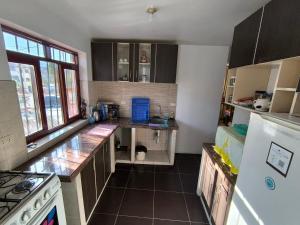 a kitchen with a counter and a refrigerator at Casa Waraq in Huaraz +22 photos