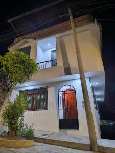 a house with a red door on the side of it at Casa Waraq in Huaraz