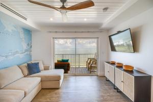 a living room with a couch and a ceiling fan at Florida Keys Getaway with Stunning Ocean Views in Layton