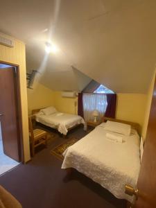 Postel nebo postele na pokoji v ubytování Hotel Küyen-Ko Pucón