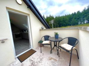 a patio with a table and chairs on a balcony at View 37 Apartment in Greencastle