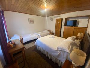 Postel nebo postele na pokoji v ubytování Hotel Küyen-Ko Pucón