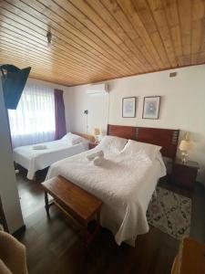 Postel nebo postele na pokoji v ubytování Hotel Küyen-Ko Pucón