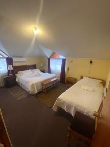Postel nebo postele na pokoji v ubytování Hotel Küyen-Ko Pucón