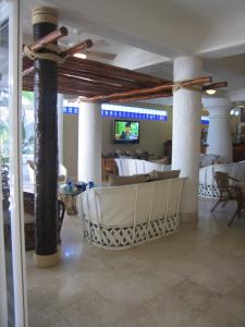 a dining room with columns and a table with chairs at Club Cascadas de Baja in Cabo San Lucas