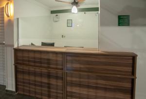 a wooden counter in a room with a ceiling fan at Hotel XV in Piracicaba