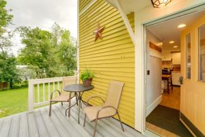 a patio with a table and chairs on a porch at The Watson House about 16 Mi to Sebago Lake! in Cornish