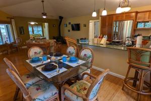 a kitchen and living room with a table and chairs at Local Living in Volcano Hawaii Breeze&5 mins to Volcano National Park in Volcano +37 photos