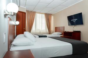 Postel nebo postele na pokoji v ubytování Grand Hotel Machala