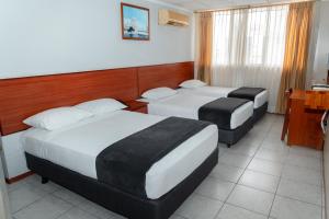 Postel nebo postele na pokoji v ubytování Grand Hotel Machala