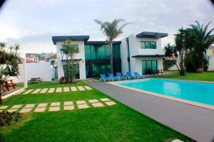 a villa with a swimming pool in front of a house at Exceptional villa in Vila Franca Do Campo with private pool in Vila Franca do Campo +26 photos