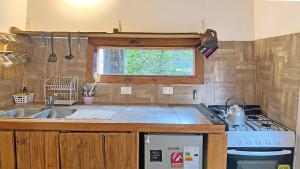 a kitchen with a sink and a stove at Casa Moderna entre Coihues in San Carlos de Bariloche