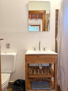 a bathroom with a sink and a mirror at Casa Moderna entre Coihues in San Carlos de Bariloche