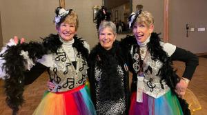 three women dressed in costumes posing for a picture at Carmel Comfort in Carmel