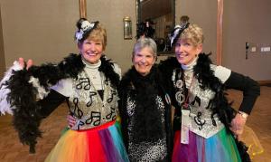 three women dressed in costumes posing for a picture at Carmel Comfort in Carmel +1 photo