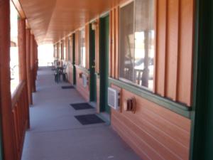 an empty hallway of a building with tables and chairs at Western Motel Ranchester in Ranchester