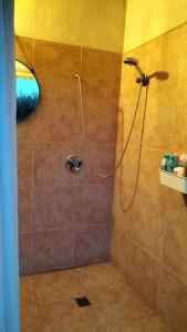 a bathroom with a shower with a shower head at le 1387 l'étape en Provence in Plan-dʼOrgon