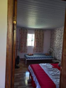 Ένα ή περισσότερα κρεβάτια σε δωμάτιο στο Casa de temporada Búzios