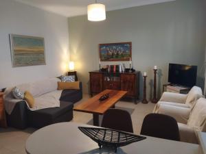 a living room with a couch and a table at 3 STEPS in Alexandroupoli