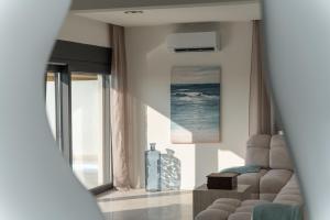 a living room with a couch and a large window at Villa Mia with Heated Pool in Maslenica